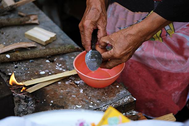 Hands preparing traditional Indonesian serabi batter using coconut milk. Authentic cooking process highlighting local Asian food craftsmanship.