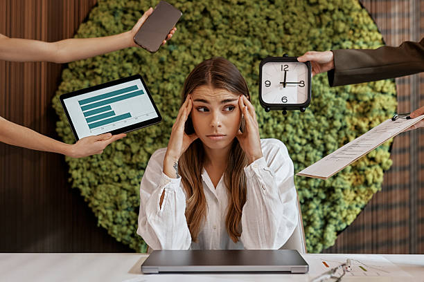 istock Stressed businesswoman overwhelmed with tasks in modern office 2255667589