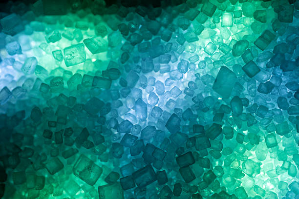 Macro Texture of Crystalline Table Sugar Particles on Multicolored LED Background