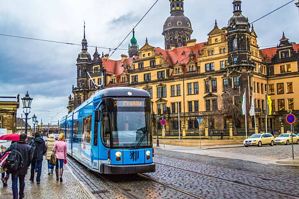 Dresden,Saxony,Germany-December 19 2014:Dresden historic street with Dresden Castle or Palace blue tram approaching on gloomy rainy winter day