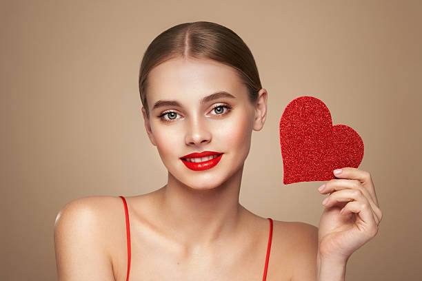istock Beautiful woman holding an artificial red heart 2255677741