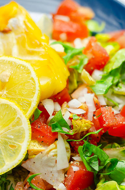 A plate of food with a fish and a lemon on it. The fish is cut into pieces and the lemon is sliced