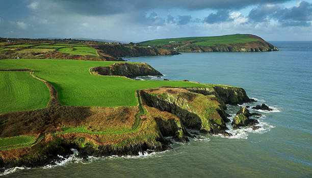 Vibrant green Pembrokeshire coastline in dramatic light,  Wales