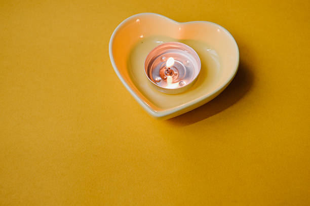 Top view of a brown heart-shaped candle isolated on white