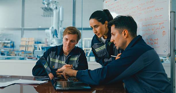 istock Group of engineers in factory meeting, collaborating and analyzing data on laptop, focusing on project development and teamwork. Robotic Industrial Factory. 2255686452