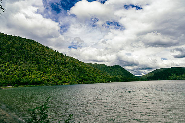 Serene water rests below dramatic cloudy sky landscape nature outdoor scenic