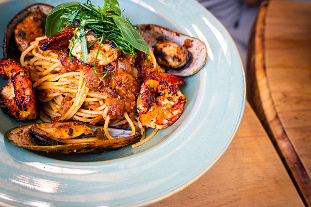 Plate of pasta with shrimp and vegetables