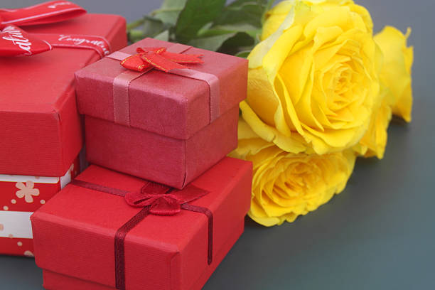 A close-up shot of a present box and figure of a couples kissing on it