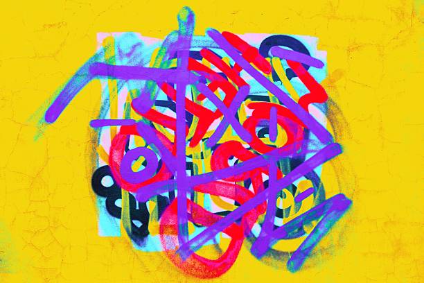 Color image of a wall that has graffiti designs on it.