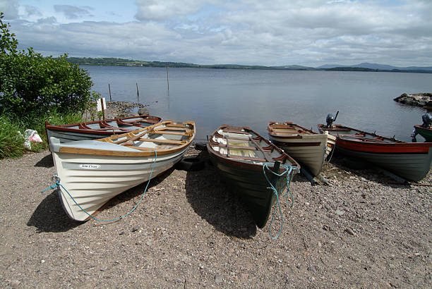Boats near the water with reflection of purple flowers