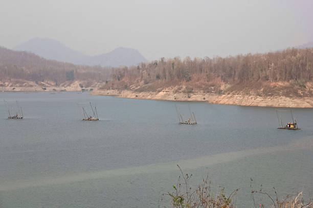 Large fishing gear (called a yo-yok) in the lake amidst smoke from a wildfire.