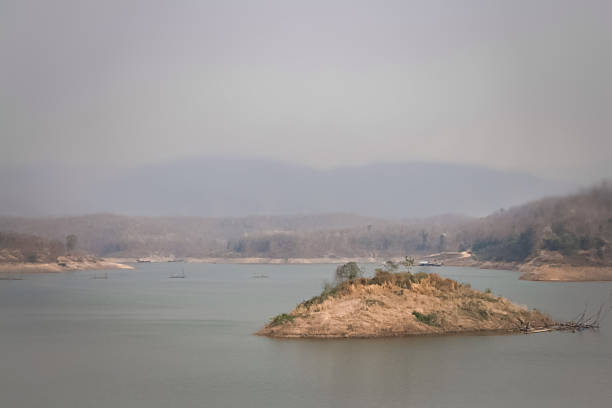 A large reservoir amidst the smoke of wildfires during the dry season.