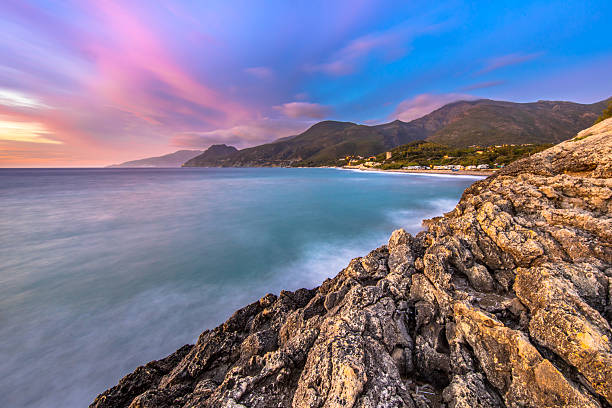 Sunset over Mediterranean sea and rocky coastline of Cap Corse near Farinole, Corsica, France, August