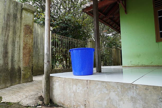 istock Blue Plastic Bucket on Backyard Tiled Patio 2255719285