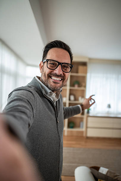 istock Happy man taking selfie presenting home interior 2255720114