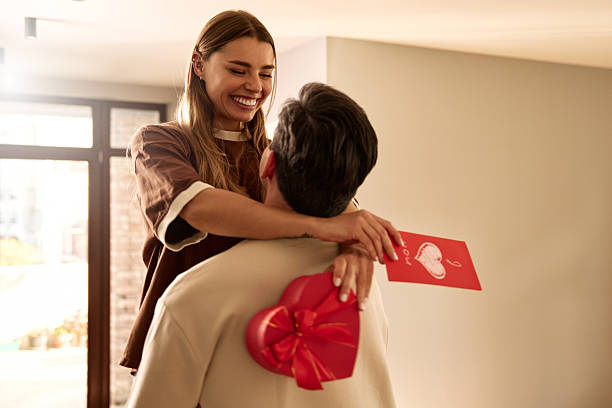 istock Couple exchanging heart shaped gift box on Valentine's Day, top view 2255723830