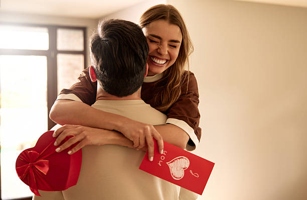 istock Couple exchanging heart shaped gift box on Valentine's Day, top view 2255723854