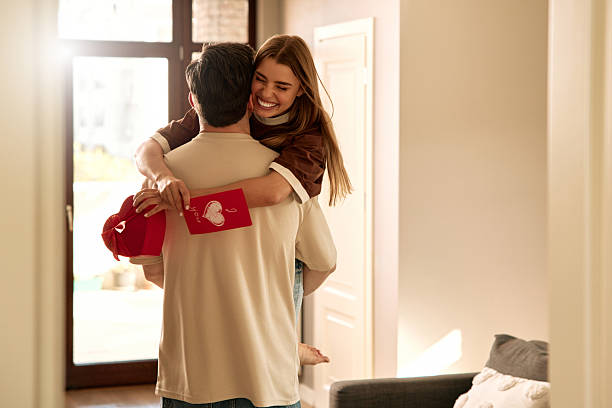 istock Couple exchanging heart shaped gift box on Valentine's Day, top view 2255723871
