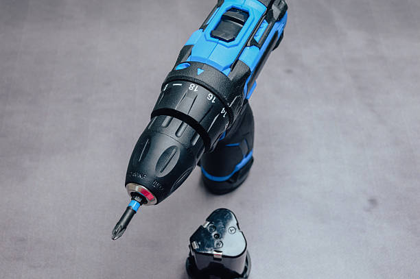 istock Blue cordless electric drill with battery pack on a neutral background, modern power tool for home improvement, DIY projects, repairs, construction and professional use. 2255731921