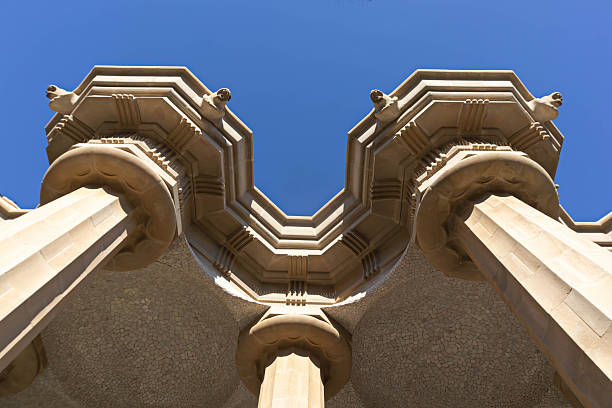Modernist stone architecture at Park Guell with columns and roof details captured in natural daylight