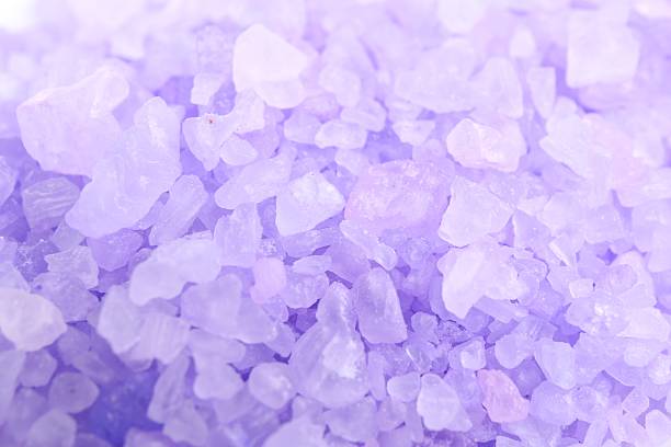 Violet sea salt as background, closeup view