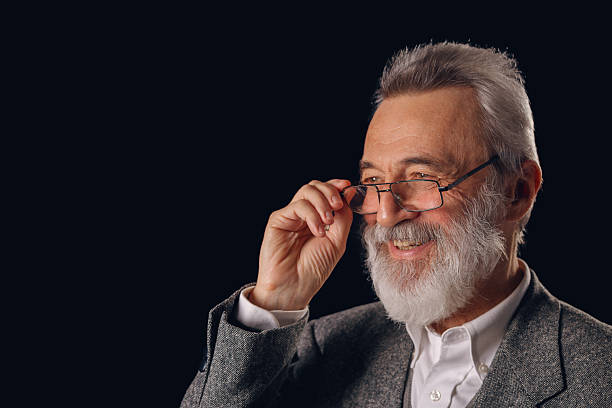istock Senior man smiling adjusting eyeglasses looking away 2255751967