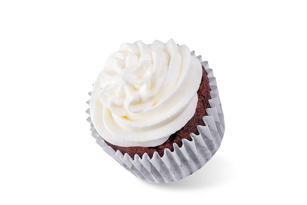 Brightly colored dessert cups are arranged in bakery case each cup, shaped like flower, is topped with fluffy whipped cream, decorative green accents.