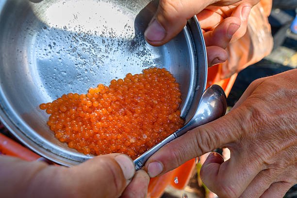 Caviar placed between the thumb and index finger on the back of the hand for tasting.