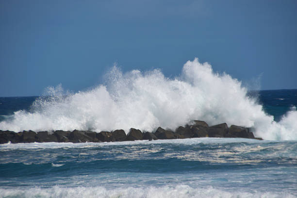 A wall of spray produced by a large wave crashing against the coastal defences in Puerto De La Cruz, Tenerife.