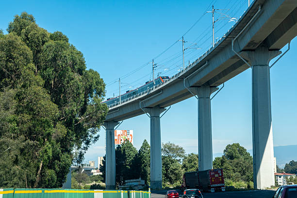 Mexico city, mexico, 10 19 2025: elevated commuter train running on a concrete viaduct, showcasing modern public transportation