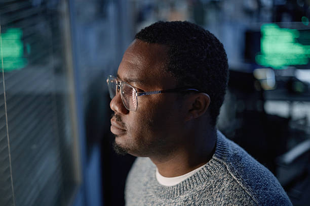 istock Middle Aged Black Man Contemplating While Standing near Office Window 2255821020