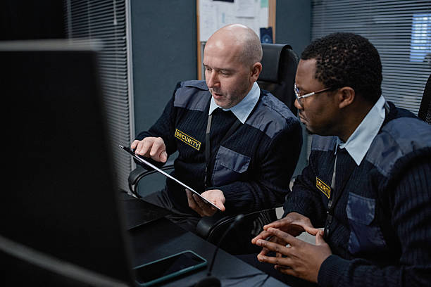 istock Middle Aged Caucasian Man and Young Black Man Discussing Security Strategy 2255822398
