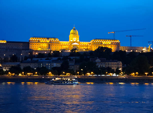 The Danube river with the Buda Castle at night, the historical castle and palace complex of the Hungarian kings in Budapest, Hungary.