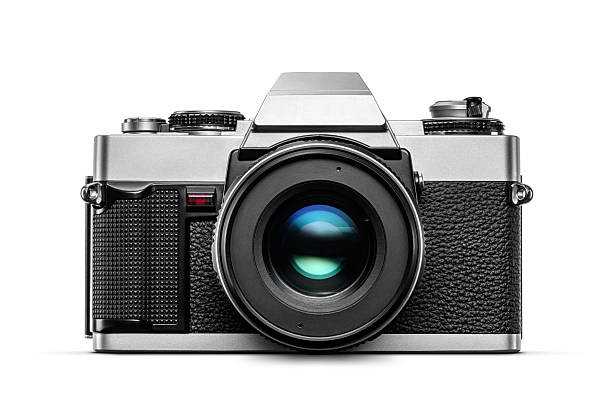 Vintage analog film camera with lens isolated on white background, front view.