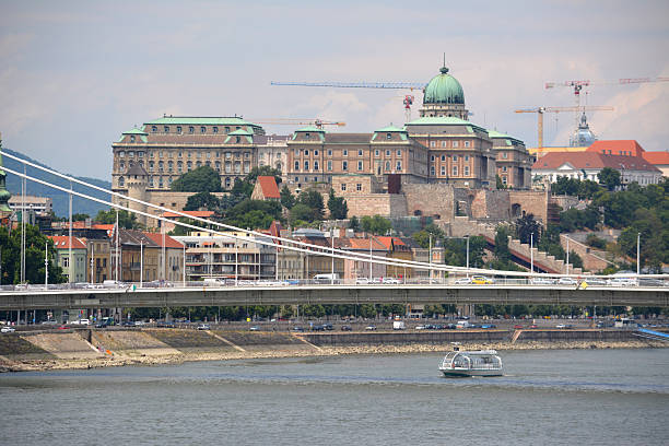 The Elisabeth Bridge, connecting Buda and Pest across the River Danube. The bridge spanning only 290 m. It is named after Elisabeth of Bavaria, a popular queen and empress of Austria-Hungary, who was assassinated in 1898. In the distance, the majestic Buda Castle.