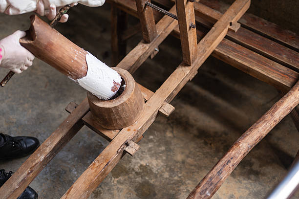 A manual lever press is used to create natural noodles in a traditional workshop setting. The scene highlights the craftsmanship, tools, and heritage behind this time-honored food-making process.