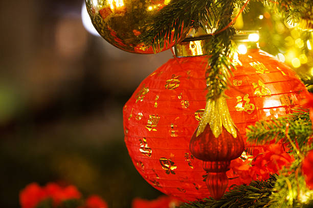 Bright red lanterns shine warmly amidst lush greenery, creating a cheerful atmosphere for a festive gathering.