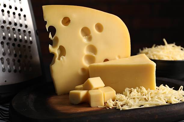 Grated and cut cheese on table, closeup