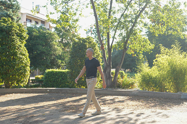 istock A man is walking in a park with trees and bushes 2255839337