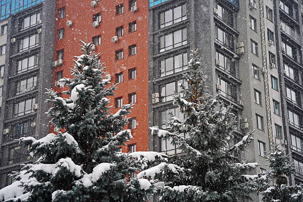 a snow covered field with a house and trees in the background
