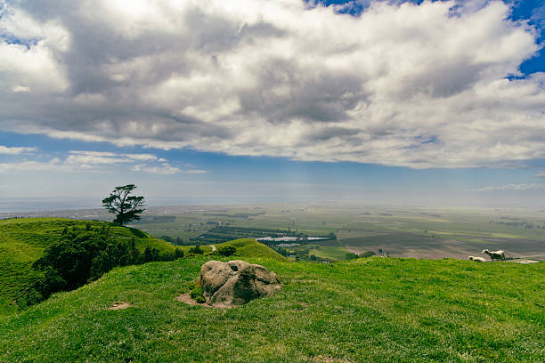 Rolling countryside stretches under dramatic clouds hillside pasture meadow