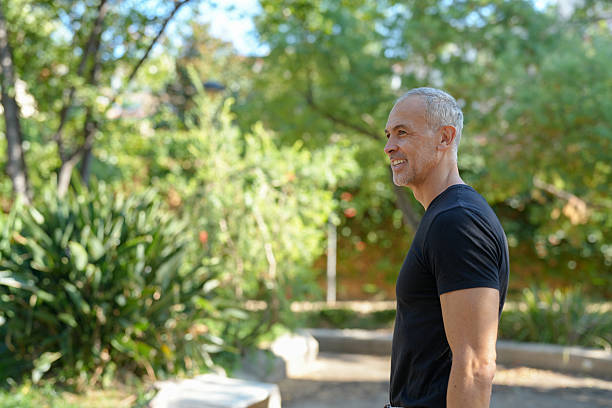 istock A man in a black shirt is standing in a park 2255842898