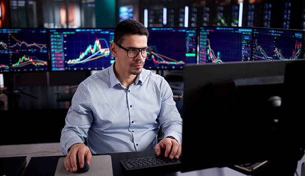 istock Hispanic Stock Broker Examining Online Trades 2255845162