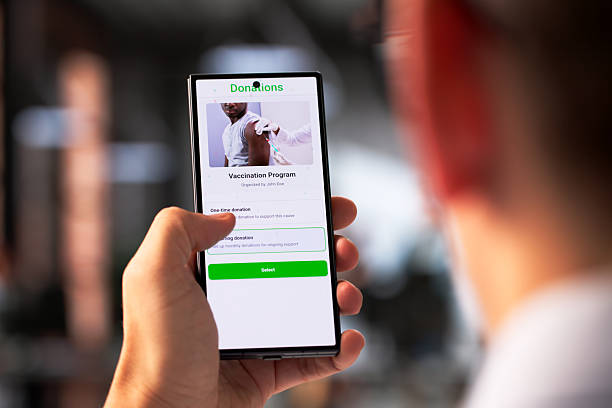 istock Generous Man Using Smartphone To Donate Money 2255846169