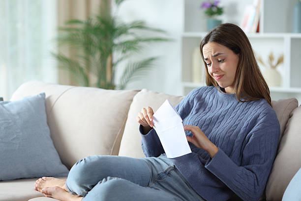 istock Doubtful woman putting letter in envelope 2255853336
