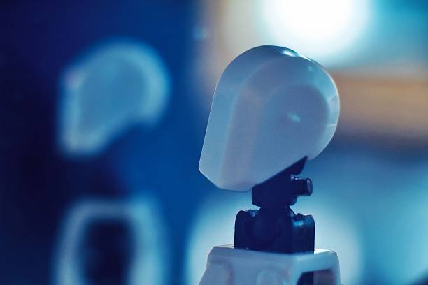 Paris, France - May 14, 2015: image of plastic figurine Lewis Galoob toys (1994), Micro Machines, interactive R2D2 toy robot, which has been shot on black textured table and colored light painting background. R2D2 is a fictional robot personnage, from the Star Wars saga films created by George Lucas in 1977 (LucasFilm ldt).