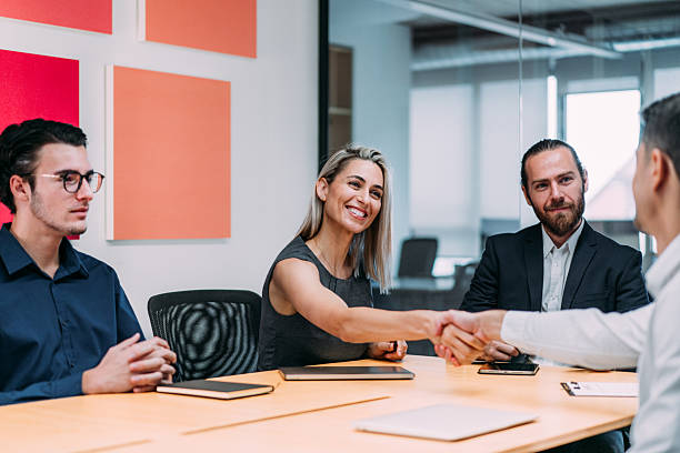 istock Businesspeople shaking hands across the table. 2255860814