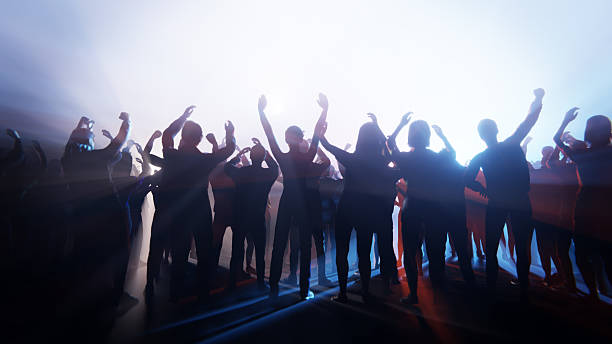 Crowd of people enjoy in outdoor public musical concert event
