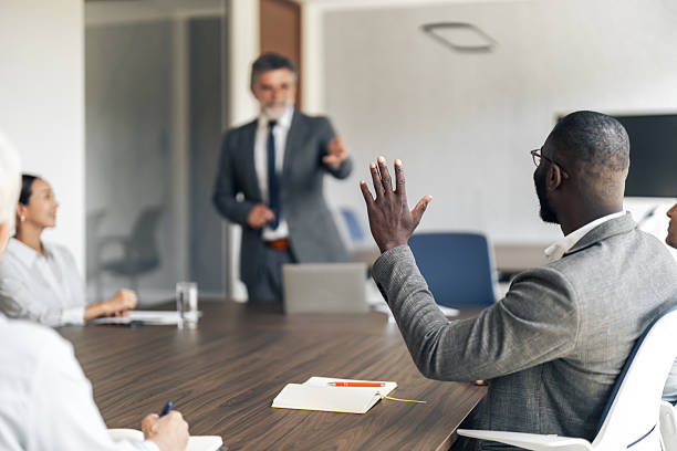 istock Business professional raising hand asking question during meeting 2255863680