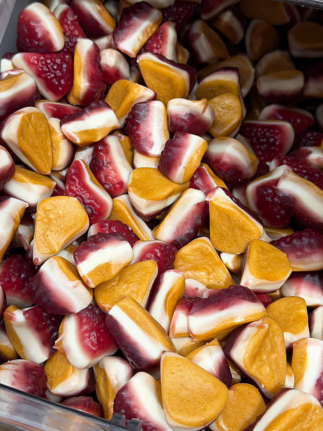 Image of blackcurrant cheesecake chewy sweets displayed in sweet shop scoop, colorful pic and mix candy selection